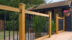 an image of a wooden deck with wrought iron railings on the front and side