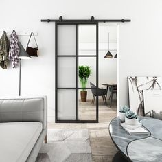 a living room with a couch, coffee table and sliding glass doors that lead into the dining area