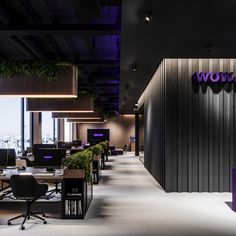 the interior of an office building with purple and black accents on the walls, along with two rows of desks