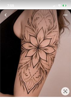 a woman's arm with a flower tattoo on it