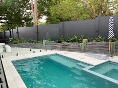 Designed by Penelope Ellen Interiors and exteriors in Melbourne ViC Pool And Retaining Wall, Tile Fence Wall, Retaining Wall Next To Pool, Pool Area Retaining Wall, Pools With Retaining Wall, Pool Next To Retaining Wall, Pools With Retaining Walls Design, Concrete Sleeper Retaining Wall, Courtyard Tiles