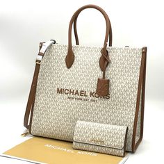 Brand New With Tag Michael Kors Mk Mirella Largew Ew Tote Bag Crafted From Durable Canvas In A Structured Silhouette, Our Mirella Tote Features Gradient Stripes And A Heart-Shaped Mk Charm. With Smooth Leather Accents And A Roomy Interior, This Bag Will Be Your New Daytime Go-To. Wear It With Denim And A Classic White Shirt. Details Color: Vanilla Tote Bag In Gold-Tone Hardware 15.75”W X 14”H X 6.5”D Handle Drop: 4.5” Adjustable Strap: 15”-25” Interior Details: Back Zip Pocket, Front Slip Pocket Cream Logo Bag For Daily Use, Luxury White Wallets For Everyday Use, White Michael Kors Bag With Detachable Handle, White Rectangular Wallet With Removable Pouch, Michael Kors Beige Rectangular Wallet, White Wallets With Removable Pouch For Everyday Use, Michael Kors White Rectangular Wallet, Michael Kors White Everyday Wallet, Michael Kors Luxury Beige Wallet