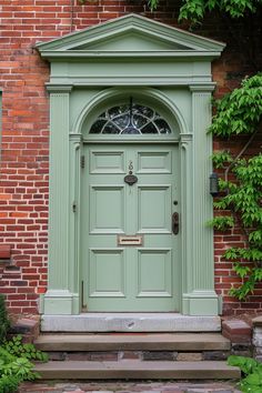 a green door is on the side of a brick building