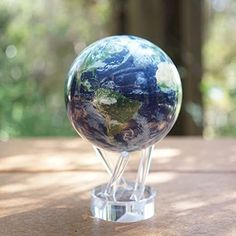 a glass globe sitting on top of a wooden table