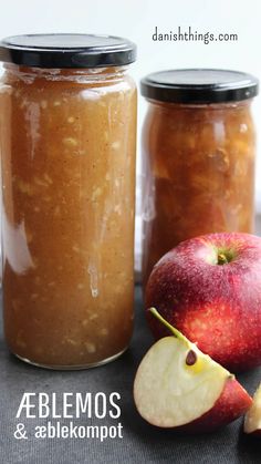 two jars filled with apple jam next to an apple