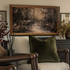 a living room filled with lots of furniture and paintings on the wall above it's couch