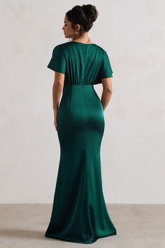 a woman in a green dress looking back