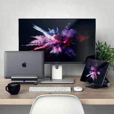 an apple desktop computer sitting on top of a wooden desk