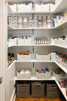 an organized pantry with white bins filled with food