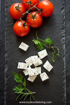 tomatoes, cheese and parsley on a slate board