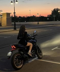 a woman riding on the back of a motorcycle