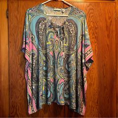 Nwot Susan Graver Branded Paisley Top, Size Large. All Over Paisley Top In Blues, Pinks, Purple, Greens And White. Lace Up Detail At Front Neckline. No Tags Attached But Protective Papers Still On Tie Ends. 95% Polyester And 5% Spandex A288493 119 B604 Casual Multicolor Paisley Print Tops, Pink Paisley Print V-neck Top, Pink V-neck Top With Paisley Print, Casual Pink Paisley Print Tops, Multicolor Paisley Print Tops For Vacation, Pink Tunic, Paisley Top, Eyelet Top, Susan Graver