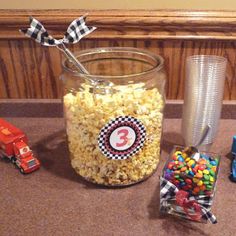 a table topped with a glass jar filled with candy