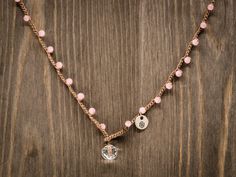 This handmade necklace comes with 4mm matte pink cat's eye glass beads crocheted on a brown cord with a 10mm crystal faceted bead closure. Depending on the length you choose, this could also be doubled around as a bracelet and/or anklet.