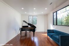 a living room with a couch and a piano