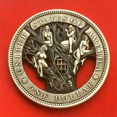 a silver coin with the image of three women sitting on top of a tree in front of a red background