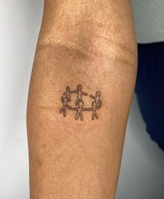 a person with a tattoo on their arm that has two people holding each other's hands