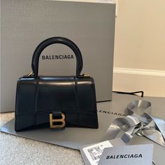 This Has Been Used Maybe Five Times At Most! Perfect Condition! See All Pictures. Never Used Long Strap. Long Strap Included And Box And Balenciaga Bag I Can Ship Too. Picture Of Receipt Can Be Provided Upon Request. Was Purchased At Saint Laurent In Galleria Mall In Houston. Will Be Authenticated By Posh! Ships Same Day Balanciaga Bag, Balenciaga Mini Bag, Balenciaga Aesthetic, Balenciaga Hourglass Bag, Balenciaga Store, Balenciaga Purse, Daily Aesthetic, Galleria Mall, Bags Balenciaga