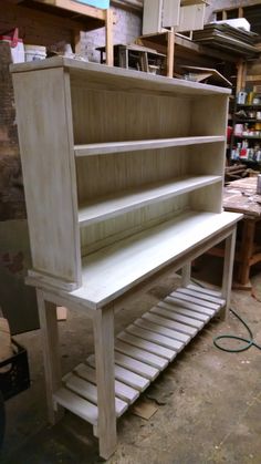 a wooden shelf with shelves on top of it