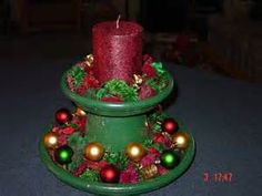 a green candle holder with ornaments on it