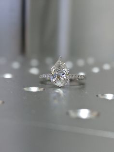 a diamond ring sitting on top of a table