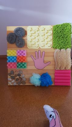 a close up of a wooden board on a table with different types of items and shapes