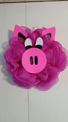 a pink pig mask hanging on the wall