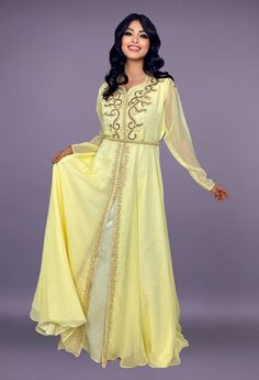 Caftan in yellow chiffon embroidered with pearls and gold threads. Belt delivered with the dress Gold Embellished Georgette Gown, Gold Gown With Intricate Embroidery And Long Sleeves, Gold Dresses With Pearl Embroidery In Traditional Drape, Elegant Gold Georgette Gown, Gold Long Sleeve Gown With Zari Work, Gold Dress With Pearl Embroidery And Traditional Drape, Gold Zari Work Long Sleeve Gown, Gold Gown With Traditional Drape In Georgette, Gold Gown In Georgette With Traditional Drape