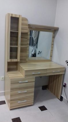 a wooden desk with drawers and a mirror