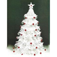 a white crocheted christmas tree with red balls