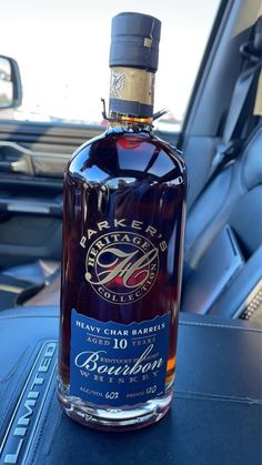 a bottle of bourbon sitting on top of a car seat