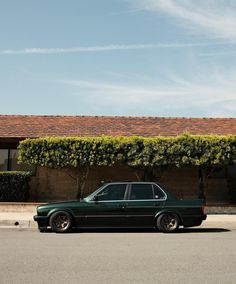 a green car parked in front of a house