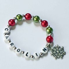 Christmas Stocking Stuffer for kids. Personalized Name Bracelet with a Holiday, Christmas theme. Personalize with name, phone number, or medical alert info. Great Party Favor or gift! This beautiful bracelet is made with high quality glass pearl beads and a silver tone snowflake charm. I hand string each order individually with care. You can personalized the name and bead color and bead type. ORDER INFO - In the personalization box please include the name and bead colors desired. You will be pro Kids Christmas Stocking, Personalized Stocking Stuffers, Bracelets For Kids, Stocking Stuffers For Adults, Personalized Stocking, Stocking Stuffers For Girls, Stocking Stuffers For Kids, Personalized Stockings, Holly Berry