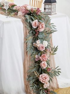 a table with flowers and greenery on it