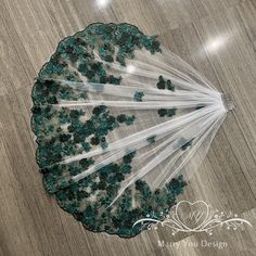 a white and green umbrella sitting on top of a wooden floor