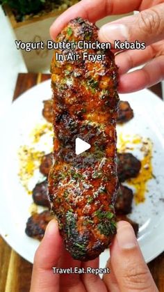 a person holding up a piece of food on a plate