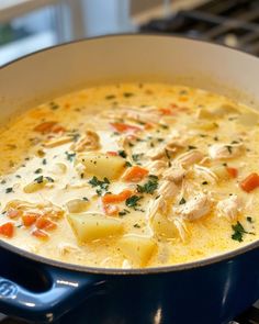 a blue pot filled with soup sitting on top of a stove