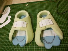 a pair of shoes sitting on top of a green cutting board