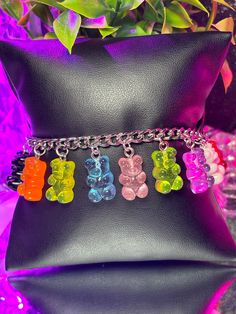 Introducing our delightful Gummy Bears Charm Bracelet – a whimsical addition to any outfit! Crafted with care, this bracelet is adjustable for the perfect fit, available in two sizes to cater to both kids and adults. For the little ones, our kid-size option starts at 5 inches and adjusts to 7 inches, while the adult size begins at 7 inches and extends to 9 inches. No matter your age, you can indulge in the charm of these sweet gummy bears! Choose between two finishes – stainless steel gold plate Trendy Plastic Jewelry For Birthdays, Cute Rainbow Charm Bracelet For Gift, Cute Rainbow Charm Bracelet As Gift, Pink Adjustable Themed Charm Bracelet, Adjustable Pink Themed Charm Bracelet, Pink Themed Adjustable Charm Bracelet, Novelty Multicolor Charm Bracelet For Birthday, Pink Adjustable Bracelet For Playtime, Adjustable Pink Bracelets For Playtime