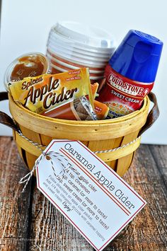 a basket filled with food and drinks next to a sign that says apple cider