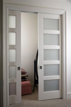 an open white door with glass panels on it