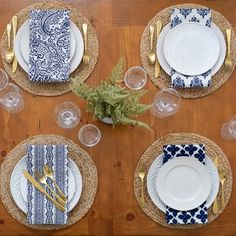 the table is set with plates and place settings