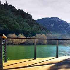 there is a bench on the deck overlooking the water