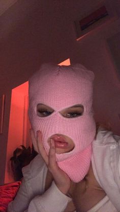 a woman wearing a pink mask covering her face