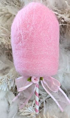 a pink candy lollipop on a white christmas tree