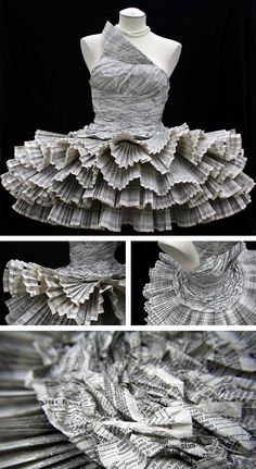 the dress is made out of newspapers and folded in folds, with an intricate pattern