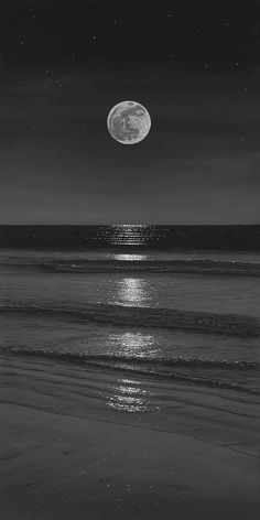 the moon is shining over the ocean on a dark night with stars in the sky