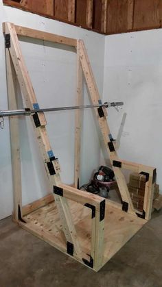 a wooden frame is being constructed to look like an upside down swing set in a garage