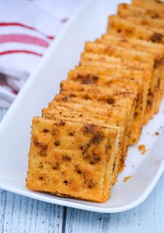 cheesy crackers sitting on a white plate