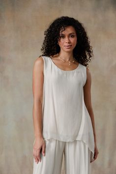 The sleeveless Marianna Silk Top showcases elegant silk layers and a flattering asymmetrical hemline, designed to wear with your favorite jeans or pants. Pair with our Madelyn Silk Pants for a chic head-to-toe look. One of our Signature Styles, part of our mix-and-match Italian Silk assortment. Classic fit. One size fits most. Boat neck sleeveless top, comfortable knit jersey lining, asymmetrical silk overlay. 100% Italian silk body, viscose lining. Hand wash, lay flat or hang to dry. Made in It Elegant Asymmetrical Summer Tank Top, Elegant Asymmetrical Hem Tank Top For Spring, Elegant Silk Top With Asymmetrical Hem, Elegant Silk Tops With Asymmetrical Hem, Elegant Asymmetrical Hem Tank Top For Summer, Elegant Layering Tops For Summer, Layered Sleeveless Tops, Chic Summer Top With Overlay, Chic Layered Summer Tops